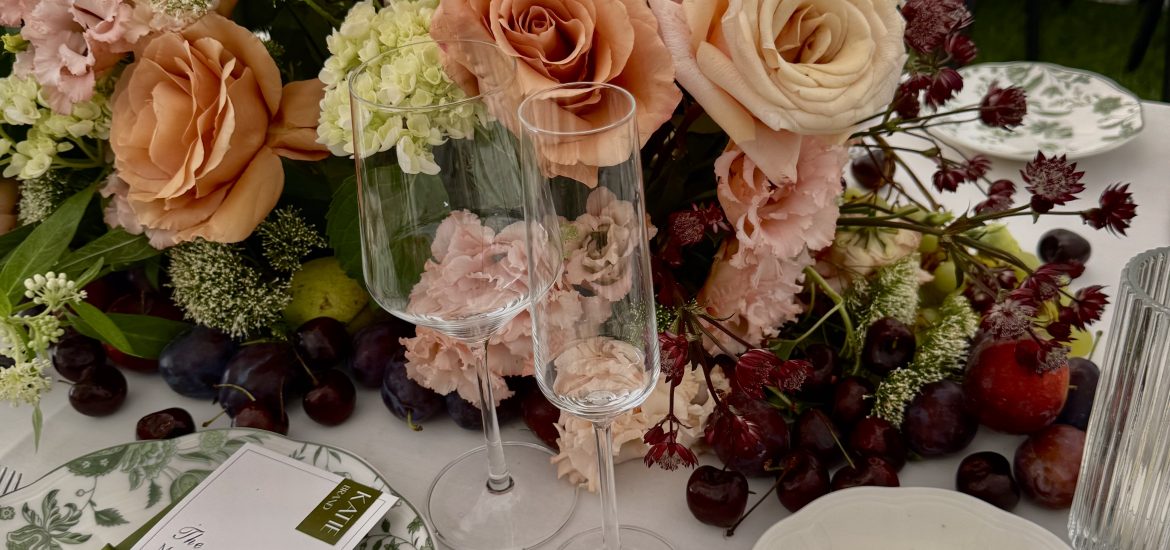 Sailcloth tent wedding on the Hudson River with locally sourced flowers, black bentwood chairs, and a black-and-white checkered dance floor.