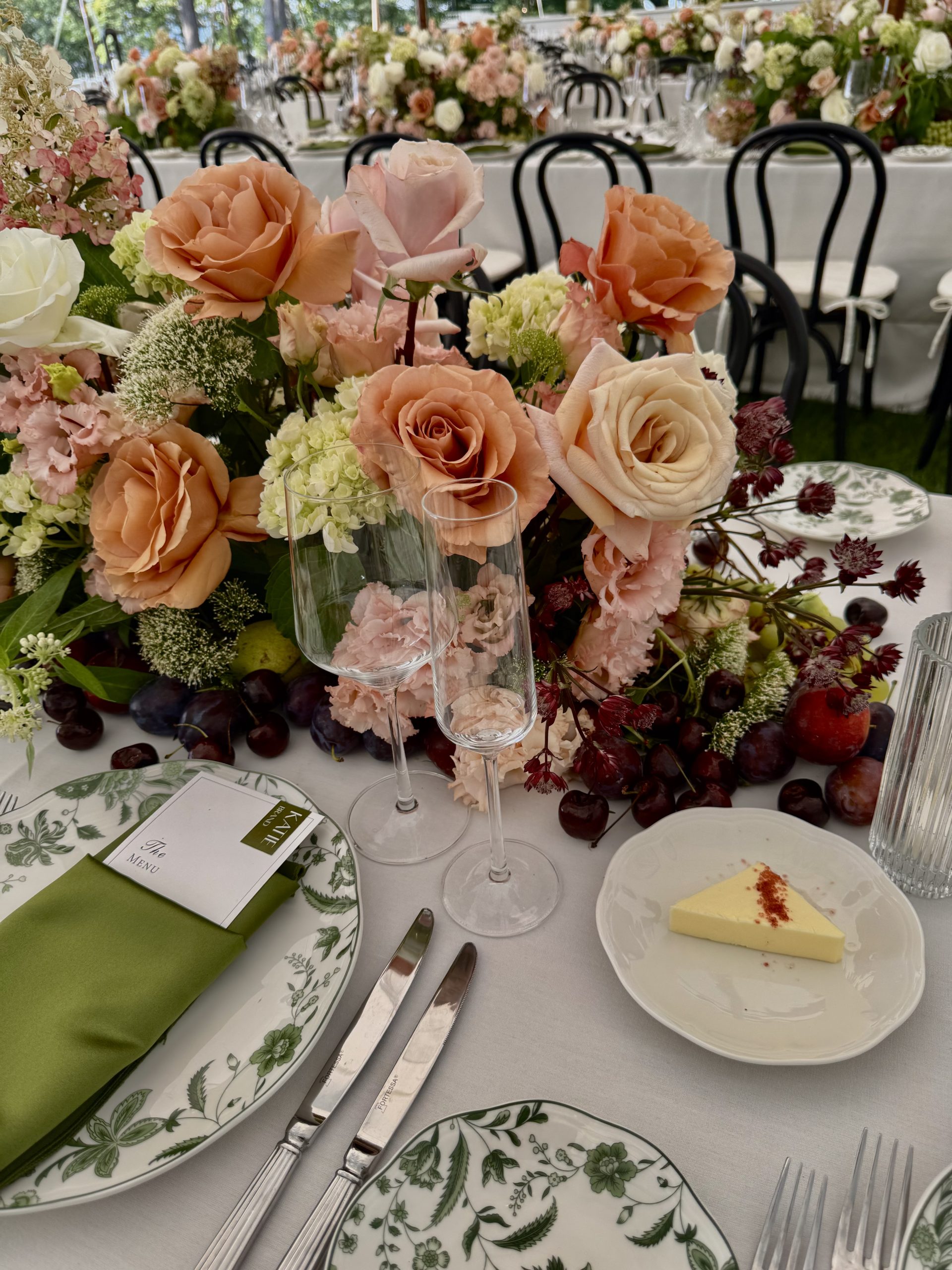Sailcloth tent wedding on the Hudson River with locally sourced flowers, black bentwood chairs, and a black-and-white checkered dance floor.