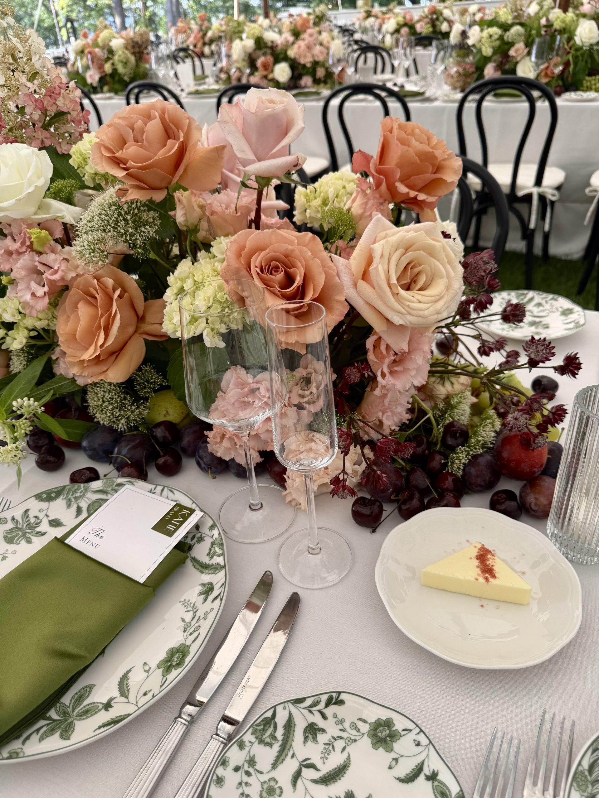 Sailcloth tent wedding on the Hudson River with locally sourced flowers, black bentwood chairs, and a black-and-white checkered dance floor.